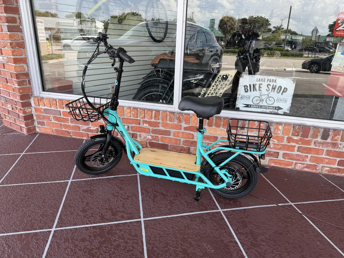A teal seated electric scooter outside Lake Park Bicycles in North Palm Beach